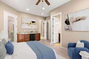 Bedroom with light colored carpet, recessed lighting, a ceiling fan, and black fridge