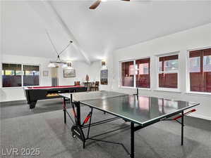 Rec room featuring dark carpet, pool table, and a ceiling fan