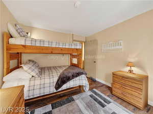 Bedroom featuring wood finished floors and baseboards