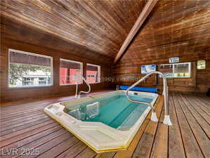 View of pool with a hot tub