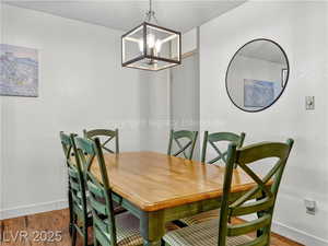 Dining area featuring wood finished floors and a chandelier