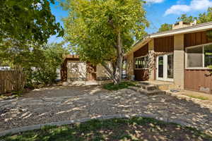 View of front of property with a chimney and board and batten siding