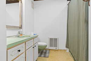 Bathroom with vanity, wood walls, and curtained shower