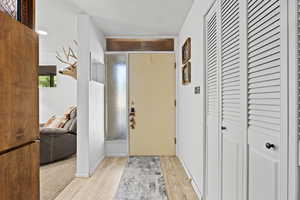 Entrance foyer featuring light wood finished floors and baseboards