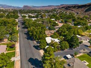 Aerial view of property's location with mountains and nearby suburban area