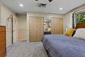 Bedroom featuring multiple closets, carpet flooring, a ceiling fan, and recessed lighting