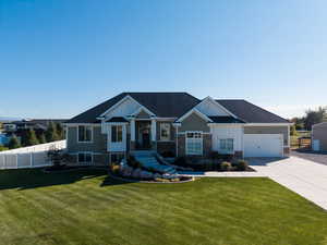 Craftsman inspired home featuring board and batten siding, driveway, stone siding, a shingled roof, and a garage