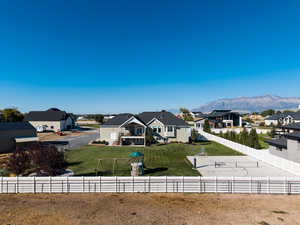 Fenced backyard with a residential view, a mountain view, and a playground