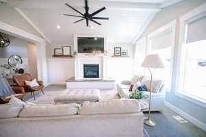 Carpeted living room with a glass covered fireplace, recessed lighting, and ceiling fan