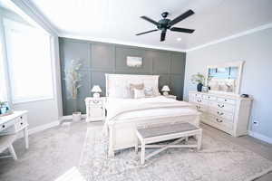Carpeted bedroom with a decorative wall and a ceiling fan