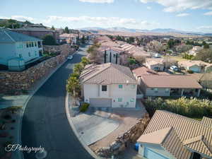 Aerial perspective of suburban area featuring a mountain backdrop