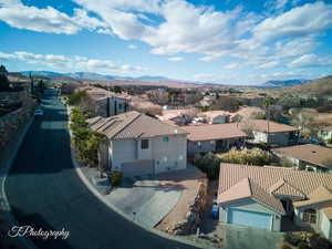 Aerial perspective of suburban area featuring a mountain backdrop