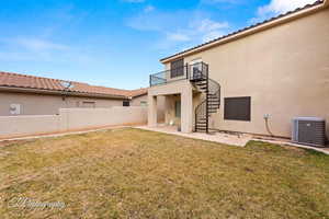 Back of property with a patio, stairway, stucco siding, and a balcony