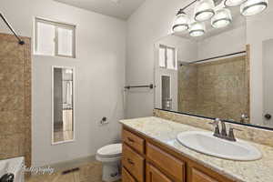 Bathroom featuring vanity, light tile patterned floors, and bathtub / shower combination