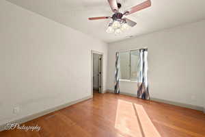 Spare room with light wood-type flooring and ceiling fan