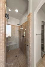 Full bathroom featuring a stall shower and light tile patterned floors