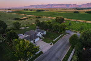 Aerial view of property's location featuring rural landscape and a mountainous background