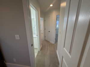Hall with light carpet and recessed lighting