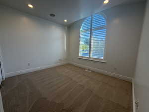 Carpeted spare room with recessed lighting