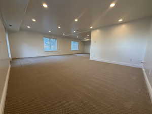 Carpeted empty room featuring recessed lighting