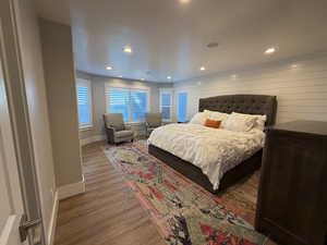 Bedroom with wood finished floors and recessed lighting