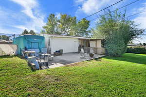 Rear view of property featuring a patio area and brick siding
