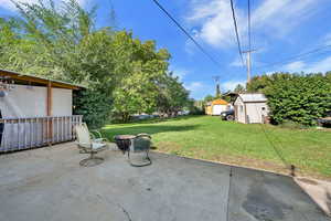 View of patio / terrace with an outdoor fire pit and a storage unit