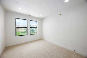 Unfurnished room featuring light carpet and recessed lighting