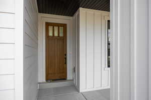 View of exterior entry featuring board and batten siding