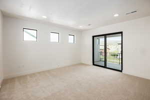 Unfurnished room with plenty of natural light, light colored carpet, and recessed lighting