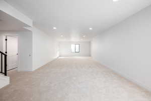 Unfurnished room featuring light carpet and recessed lighting