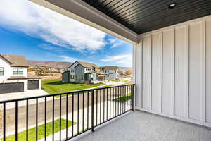 Balcony featuring a residential view and a mountain view