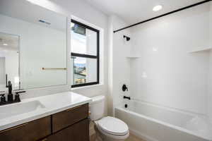 Bathroom with  shower combination, vanity, recessed lighting, and light tile patterned floors