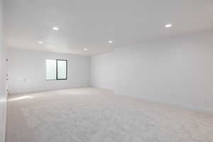 Spare room featuring light carpet and recessed lighting