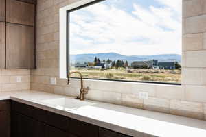 Kitchen with dark brown cabinets, a mountain view, modern cabinets, and tasteful backsplash