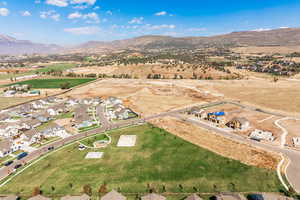 Aerial view of property's location featuring nearby suburban area and a mountain backdrop