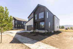 View of front of property featuring driveway and a garage