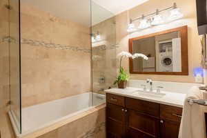 Full bath with large soaking tub and laundry area