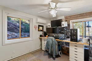 Office featuring carpet floors, a ceiling fan, a textured ceiling, and an AC wall unit