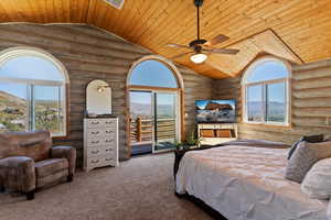 Carpeted bedroom with wood ceiling, access to exterior, a ceiling fan, high vaulted ceiling, and log walls