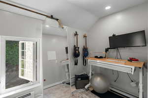 Office area with baseboard heating, vaulted ceiling, and recessed lighting