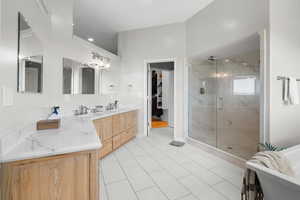 Ensuite bathroom with a marble finish shower, double vanity, a soaking tub, light tile patterned floors, and recessed lighting