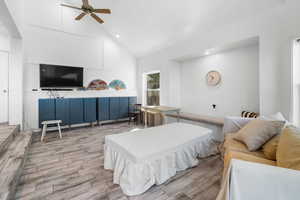Family room with wood look tile floors, high vaulted ceiling, recessed lighting, and ceiling fan