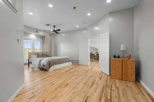 Master bedroom featuring recessed lighting, hardwood flooring, ceiling fan, balcony and a baseboard radiator