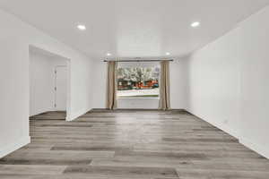Empty room with recessed lighting and light wood-style flooring