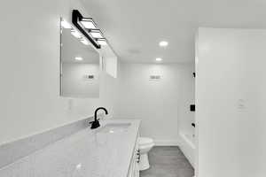 Bathroom featuring vanity, recessed lighting, and shower / bathtub combination