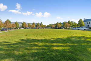 View of property's community with a lawn and a residential view
