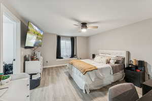 Bedroom with luxury vinyl floors and ceiling fan
