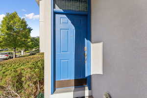 Property entrance with stucco siding