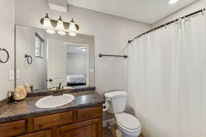 Full bath with vanity, connected bathroom, and a shower with curtain